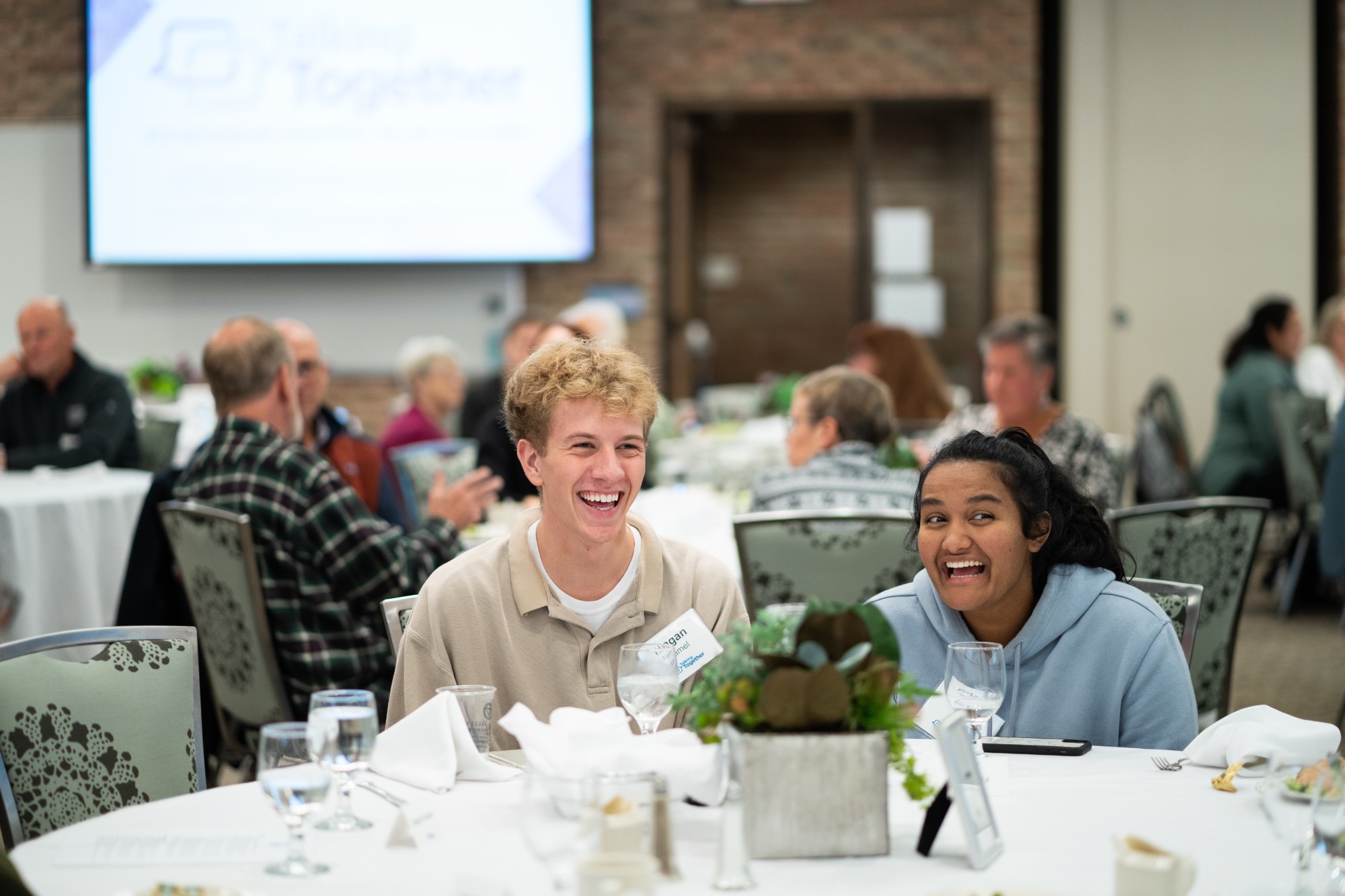 Students laughing at table